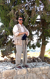 Youssef standing on Citadel of Amman Walls sharing information with tour group